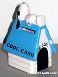 Joe Cool laying on Blue Doghouse 'Cool Cash' Bank