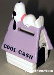 Joe Cool laying on Purple Doghouse 'Cool Cash' Bank