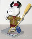 Snoopy wearing snowshoes and holding oar Figurine