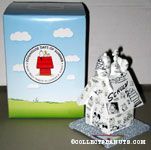Snoopy on doghouse covered in comics Figurine