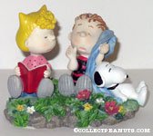 Snoopy, Sally and Linus sitting in flowers Figurine