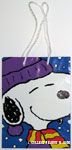 Snoopy wearing winter clothes on blue snowy background