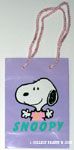 Snoopy holding out arms on purple background