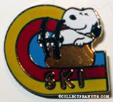 Snoopy laying on rock wearing Skis Pin