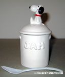 Snoopy sitting on jam jar with spoon 
