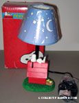 Snoopy sleeping on top of doghouse with Woodstock Lamp