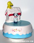 Snoopy skating on pond with doghouse and Woodstock Music Box