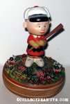 Charlie Brown standing on pitcher's mound with baseball bat Musical