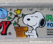 Snoopy holding potted tree with Woodstock singing Ruler