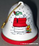 Snoopy on doghouse with wreath on his nose, Charlie Brown and Woodstock standing Bell Ornament