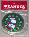 Snoopy sitting with snowman in wreath Round Metal Ornament