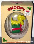 Woodstock holding green Christmas gift box Ornament