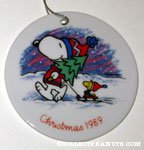 Snoopy holding tree and Woodstock on sled Ceramic Ornament