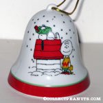 Snoopy on doghouse with wreath on his nose, Charlie Brown and Woodstock standing Bell Ornament
