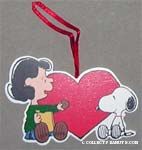 Lucy giving Snoopy cookie