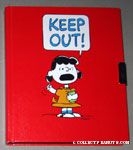 Lucy holding book and raising fist 'Keep Out' Diary