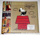 Snoopy looking at photo album on top of doghouse Photo Album