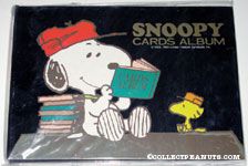 Snoopy looking through album with Woodstock Photo Album