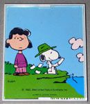 Snoopy looking through cards with Lucy Framed Print