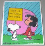 Snoopy holding sign with Lucy 'This is national dog week' Puzzle