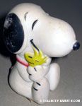 Snoopy sitting and hugging Woodstock Squeaky Toy