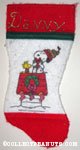 Snoopy hugging gift on doghouse with Woodstock Stocking