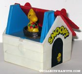 Woodstock holding flower in Dog House Toy