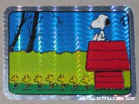 Snoopy on doghouse with line of Woodstocks Prismatic Photo/Trading Card
