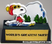 Snoopy skiing in front of mountain 'World's Greatest Skier' Trophy