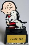 Snoopy hugging Charlie Brown
