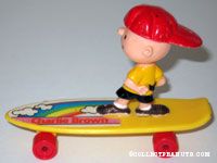 Charlie Brown standing on yellow skateboard