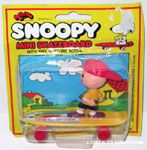 Charlie Brown standing on yellow skateboard