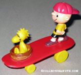 Woodstock sitting in nest and Charlie Brown standing on red curved skateboard