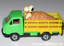 Snoopy riding in back of Hay Truck