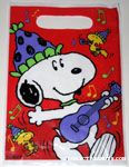Snoopy playing guitar with Woodstocks Treat Sack