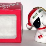 Snoopy sitting holding candy cane dated 1977 Christmas Ornament