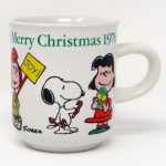 Peanuts gang holding Christmas articles Mug