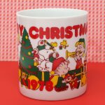Peanuts Gang opening gifts around Christmas tree Mug