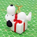 Snoopy laying on gift package Ornament