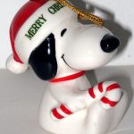 Snoopy sitting holding candy cane dated 1977 Christmas Ornament