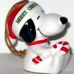 Snoopy sitting holding candy cane dated 1977 Christmas Ornament