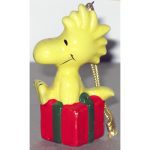Woodstock sitting on gift package Ornament