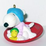 Snoopy and Woodstock on snow saucer sled Ornament