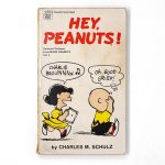 Front cover of the vintage Fawcett Crest paperback book "Hey, Peanuts!" by Charles M. Schulz, featuring Lucy playing the accordion while singing "CHARLIE BROWNNNN" and Charlie Brown covering his ears saying "OH, GOOD GRIEF!"