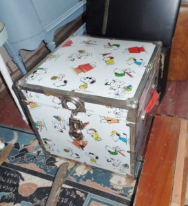 This Snoopy Trunk may be full of treasures, but it's also sitting on top of a vintage Armstong Quaker Linoleum Rug.