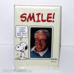 Snoopy winking 'Smile! It makes people wonder what you're up to' Picture Frame