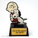 Snoopy hugging Charlie Brown