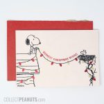 Snoopy and Woodstock stringing lights between houses Christmas Card