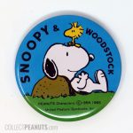 Snoopy leaning on rock with Woodstock Pin