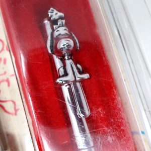 A close-up view of a Snoopy & Woodstock Pen resting inside a bright red presentation box lined with fuzzy red material, highlighting the silver pen's detailed metal clip featuring Snoopy and Woodstock figures.